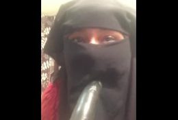 Lonely Niqabi Hijabi woman sucking dildo & shaking ass