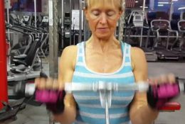 old woman with large breasts and muscular arms trains biceps 2